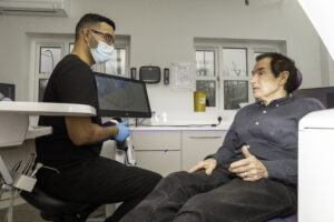 friendly dentist speaking to patient